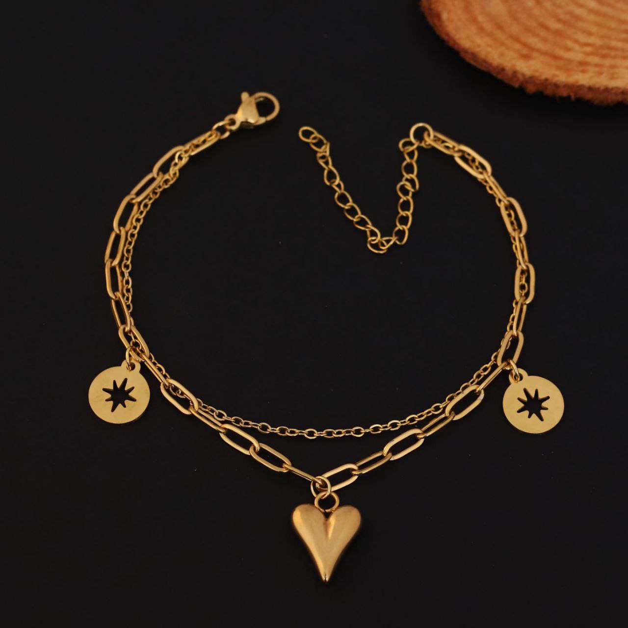 22k gold plated anti tarnish , adorned with a whimsical heart charm and a sparkling star charm that add a touch of playful sophistication CHARMORA BY ROHI